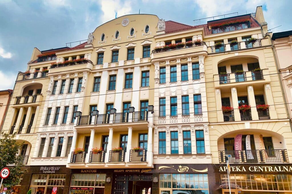 An elaborately decorated Art Nouveau facade with balconies and figurines on a historic building in Bydgoszcz